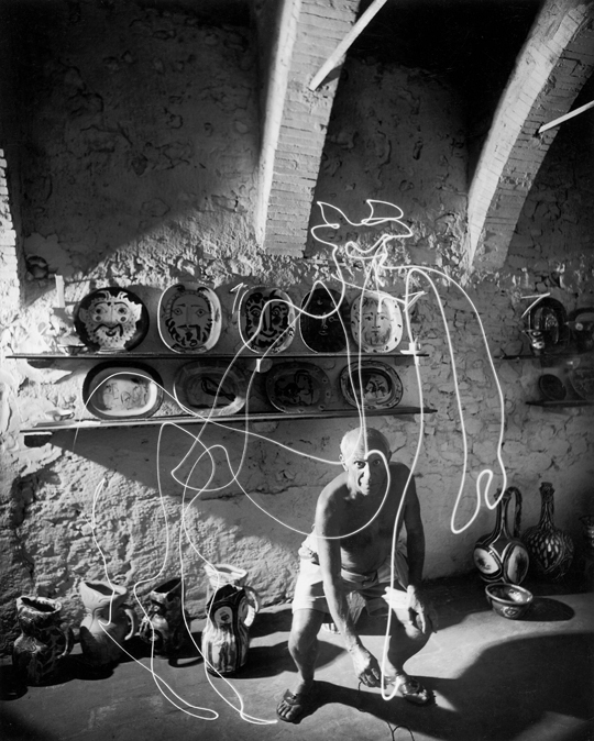 Artist Pablo Picasso painting with light at the Madoura Pottery, by Gjon Mili