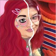 Joanna Thangiah tooned self portrait. The right half is a cartoon and the left half is a photograph. Both are the image of the artist who has long red hair, pink glasses and lips, and barrettes in hair.